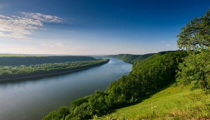 Fototapeta premium Tree Covered Hill Overlooking The River