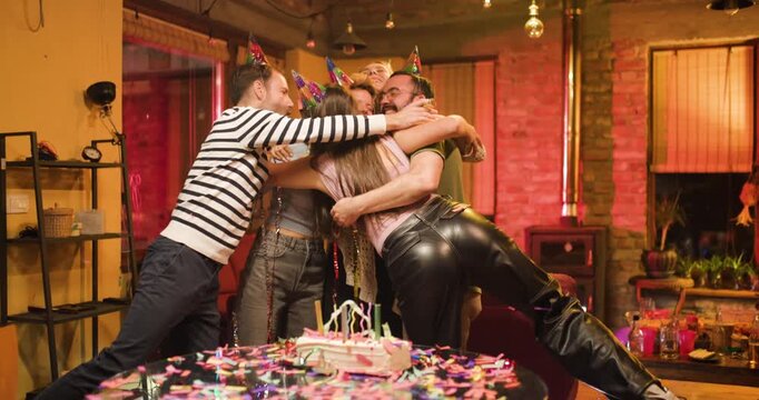 Girl celebrates her birthday with friends at home while enjoying cake and fun activities together in a cozy setting filled with laughter and joy