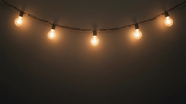 Warm Glowing Hanging Edison String Bulbs on Dark Neutral Wall Background