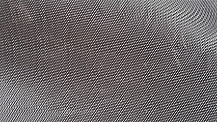 Black textured mesh fabric surface showing a repeating geometric hole pattern © Sueliton