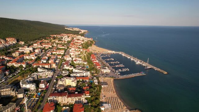 Marina port in Sveti Vlas. Panoramic aerial view of houses and hotels, sea and beaches of Sveti Vlas in Bulgaria from above, top view from drone. Summer holiday in Europe. 
