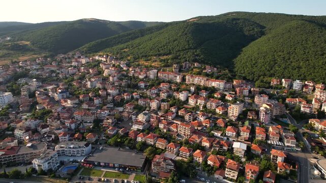 Panoramic aerial view of houses and hotels, near mountains, sea and beaches of Sveti Vlas in Bulgaria from above, top view from drone. Summer holiday in Europe. 
