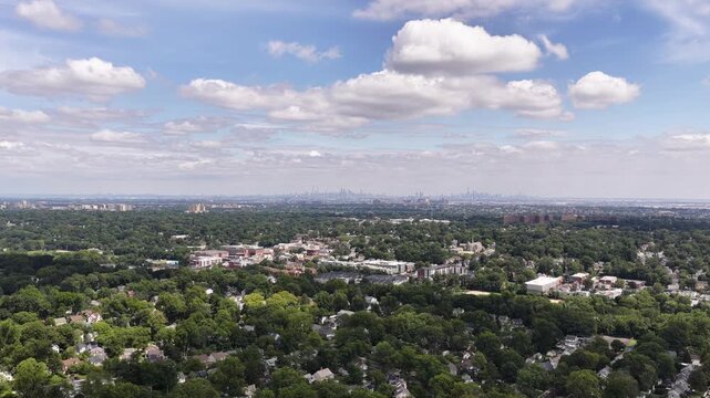 Rightward aerial pan from Manhattan skyline across Maplewood and South Orange