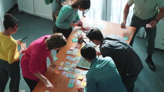 Top view of skilled programmer brainstorming idea about mobile phone interface while develop app development by using wireframe prototype. Web designer planning at table with sticky notes. Symposium.