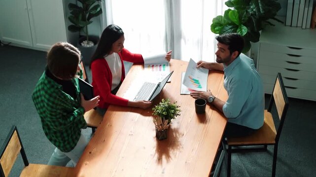 Top view of project manager present financial graph to investors at meeting. Professional marketing team brainstorming financial idea while looking at financial statistic from laptop. Convocation.