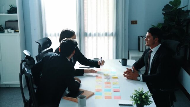 Top view of business team discuss about marketing strategy while smart manager enter meeting and talking about plan. Diverse people brainstorming idea by using sticky notes at board room. Directorate.