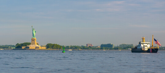 Statue of Liberty and US Coast Guard ship in New York Harbor from the water © ChristyLangPhotos