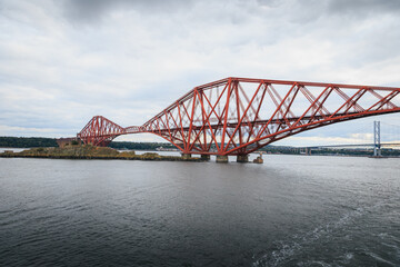 Fototapeta premium Passenger Ship Leaving Port of Rosyth and Sailing Beneath the Iconic Firth of Forth Bridges, Scotland, August 2026