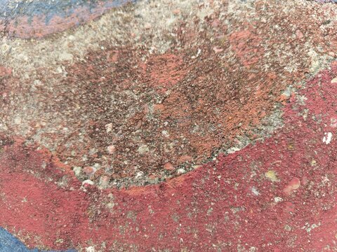 Weathered rust and coral textured wall, warm abstract urban background