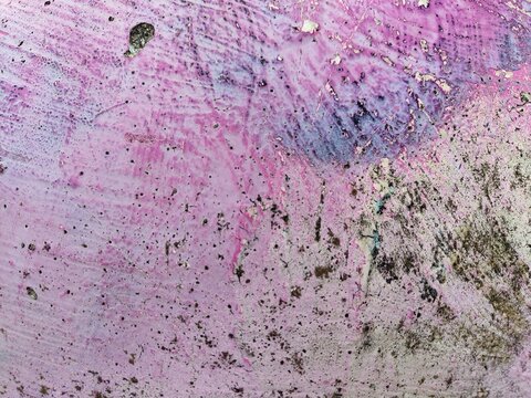 Pink and purple gradient on gritty textured surface, abstract background