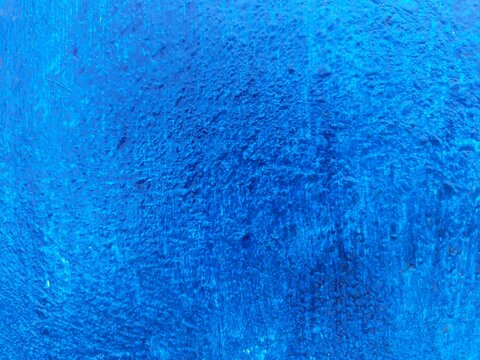 Rich saturated blue paint texture, abstract wall background