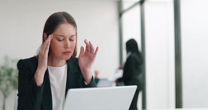 Portrait of overwhelmed female employee feels headache looking at laptop in office. Stressed blonde businesswoman works on computer in corporate environment