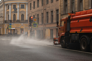 Road maintenance services are washing the asphalt on the streets of St. Petersburg with detergent. © Mikhail