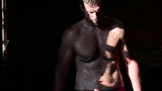 sweaty guy in and out of shadow
