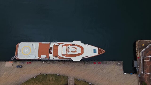Aerial views reveal the exquisite La Datcha yacht moored at the bustling pier in the heart of Halifax, Nova Scotia, blending sophistication with vibrant city life