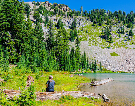 Female Hiker On The Shoreline of Emerald Lake With Eagle Peak, Lassen Volcanic National Park, California, USA