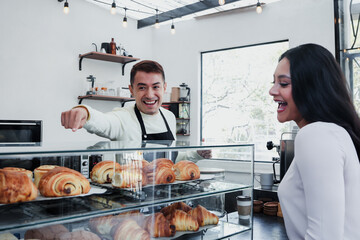 young latin man barista preparing and selling coffee in a coffeeshop in Mexico Latin America