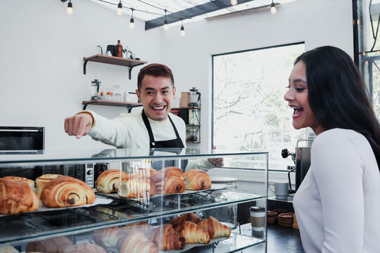 young latin man barista preparing and selling coffee in a coffeeshop in Mexico Latin America
