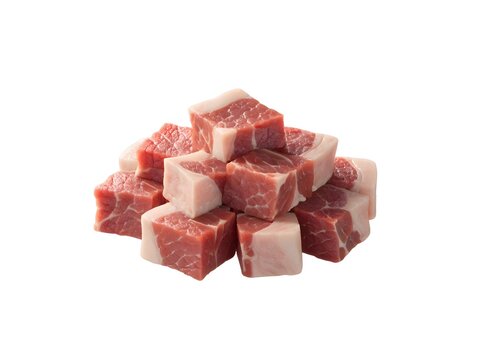 Raw diced beef meat cubes stacked on white background. Butchery cooking ingredients and fresh protein food concept. Meat pieces arranged in a small rustic pile