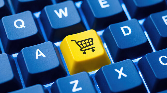 Digital e commerce shopping cart button on a blue backlit computer