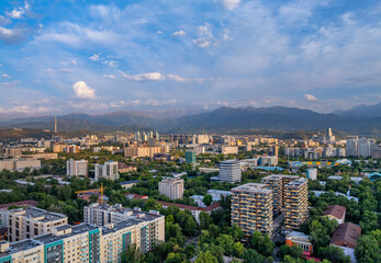 Fototapeta premium A picturesque drone view of the Kazakh city of Almaty at sunset on a summer evening.