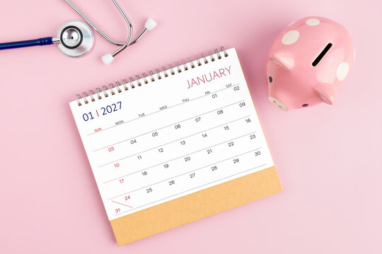 January 2027 desk calendar and stethoscope with piggy bank, Savings for Health insurance concept.