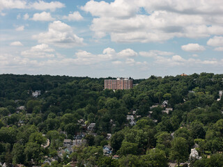 Fototapeta premium Downtown White Plains skyline above tree-filled neighborhoods in Westchester County, New York