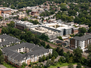 Fototapeta premium Aerial drone view of golf course fairways, nearby homes, and mature trees in Bayberry Park, New Rochelle, New York
