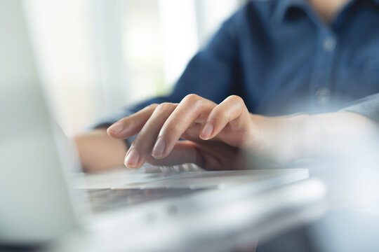 Close up of woman hand typing on laptop, working at modern office