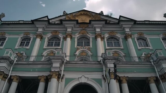 Iconic Winter Palace facade in St. Petersburg under a cloudy sky