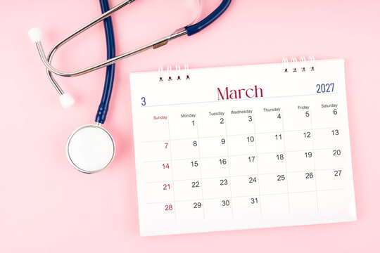 Blank March 2027 desk calendar and stethoscope, Medical appointment schedule to check up.