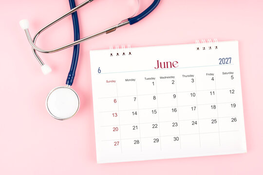 Blank June 2027 desk calendar and stethoscope, Medical appointment schedule to check up.