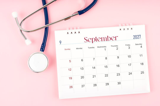 Blank September 2027 desk calendar and stethoscope, Medical appointment schedule to check up.