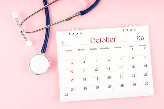 Blank October 2027 desk calendar and stethoscope, Medical appointment schedule to check up.