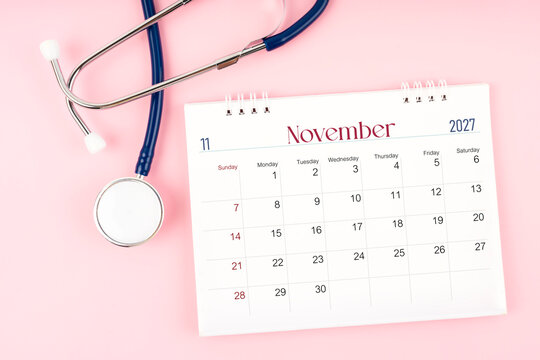 Blank November 2027 desk calendar and stethoscope, Medical appointment schedule to check up.
