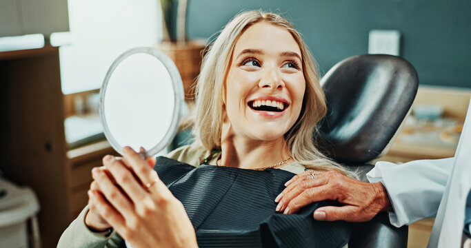 Woman, smile and healthcare with mirror for oral hygiene, results and teeth whitening at dentist clinic. Happy, patient and dental care at orthodontist for tooth cleaning, veneers and implants