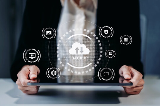 Business professional using cloud backup technology for secure data storage, file protection, recovery and digital information management