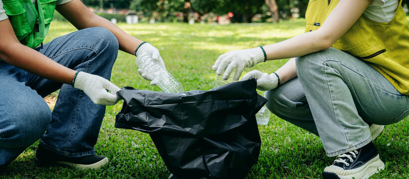 Community volunteers environmentalists gather plastic bottles fo