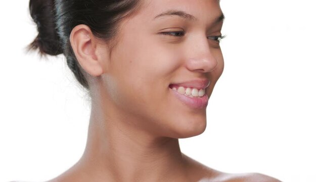 Big close-up shot of cosmetics model smiling looking aside demonstrating healthy skin on white | Face wash commercial video