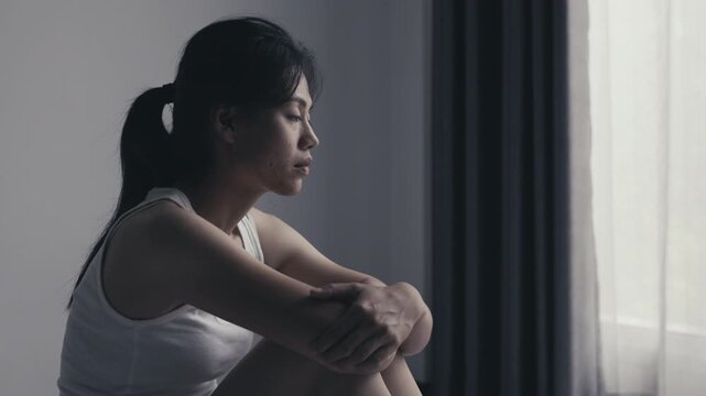 Sad woman showing signs of depression, fear and emotional trauma after experiencing abuse and difficult family problems.