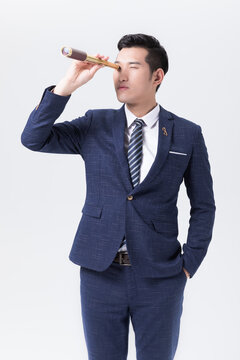 Businessman Looking Through a Telescope