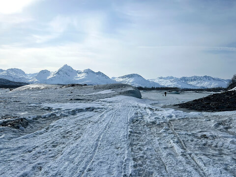 Man and dog on frozen lake in Alaska