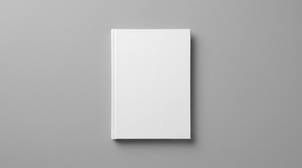 Fototapeta premium Blank White Book Cover on a Plain Gray Background with Subtle Shadowing for Design Mockups