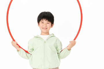 Smiling Boy Holding Red Hula Hoop on White Background © CaoBaoTran