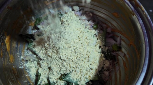 Cooking Ingredients Being Mixed Together , for fry snacks , gram flour in slow motion