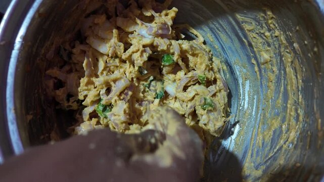 Mixing Pakora Batter with Flour and onion Close Up , ,hand mixing 