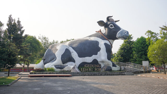Giant black and white dairy cow statue building called Gedung Lembu Sora in Boyolali, Central Java, Indonesia, representing the city iconic milk heritage and unique architectural landmark structure.