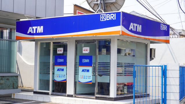 Exterior view of Bank Rakyat Indonesia (BRI) outdoor ATM booth building on a sunny day. Public financial banking services for cash withdrawal in Yogyakarta, Indonesia.