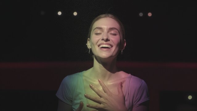 Joyful Young Woman Expressing Happiness with Bright Lighting Effects
