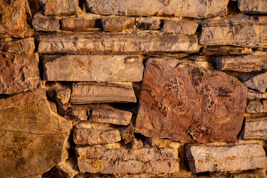 Texture background of a rough ancient stacked stone block castle wall